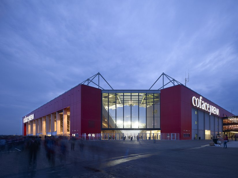 Die Coface Arena in Mainz ist ein weithin sichtbarer Anziehungspunkt – tagsüber dank der rubinroten Fassade, abends dank Illumination und nach außen dringender Spielfeldbeleuchtung.