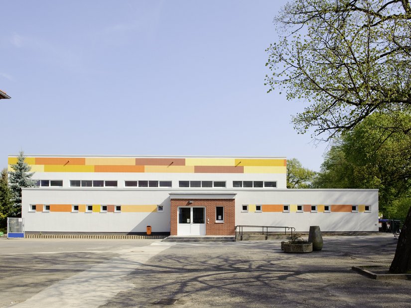 Eingangsbereich: Zusammenziehen der Fenster durch die sieben rötlichen und gelben Akzentfarben des Hauptgebäudes.